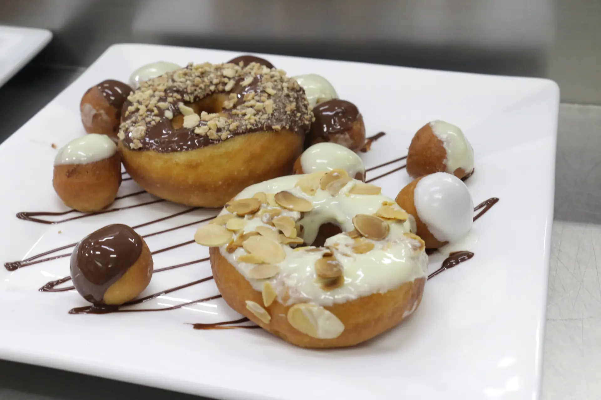 Chocolate and white glazed donuts with nuts