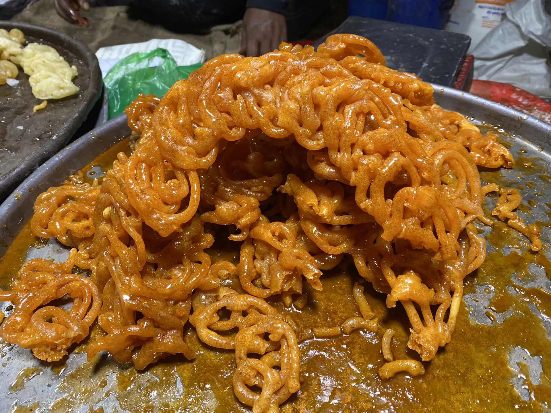 Fresh golden jalebi piled on a tray