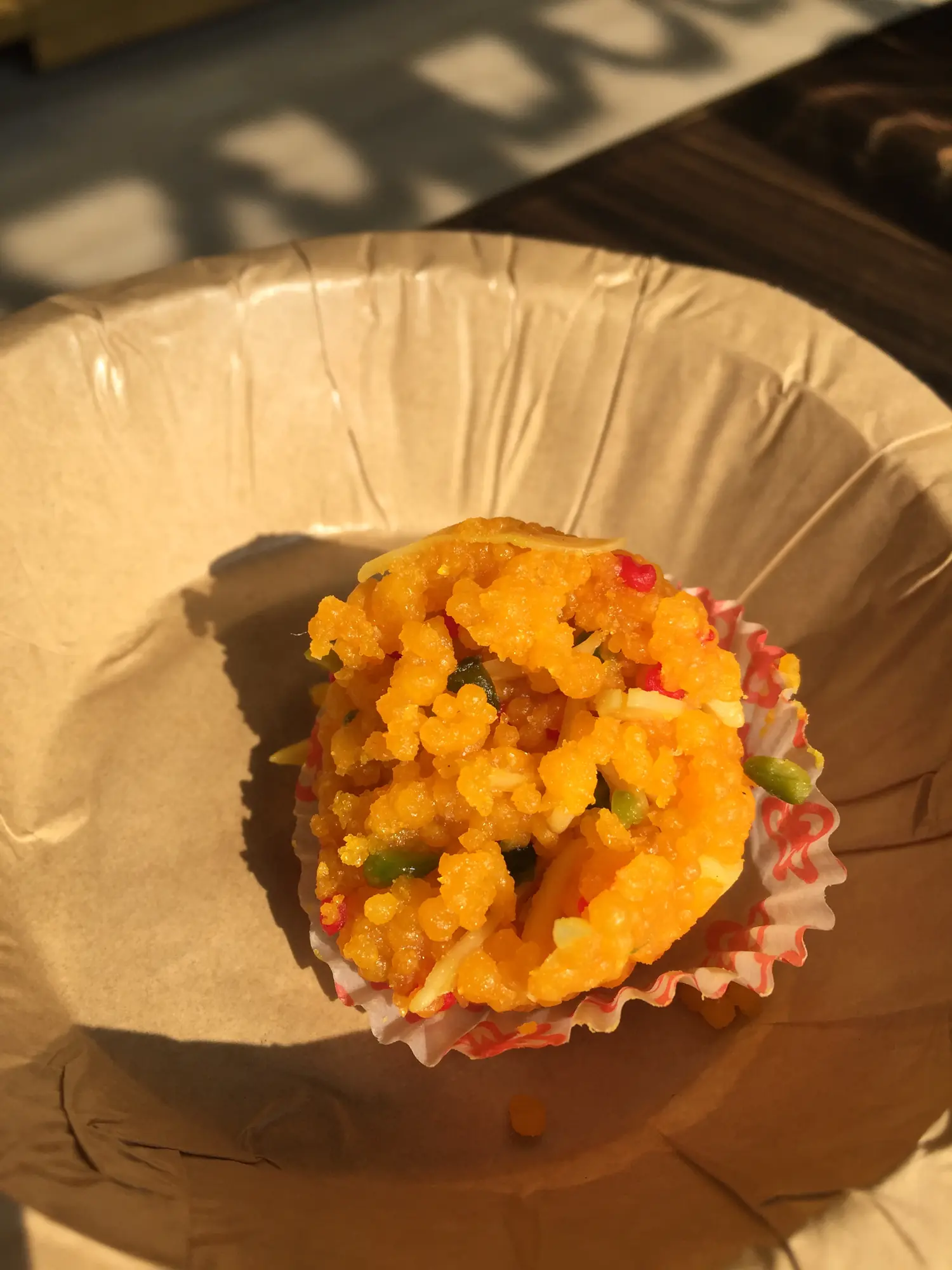 Boondi ladoo in a paper cup